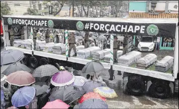  ?? ANDRE PENNER / ASSOCIATED PRESS ?? Trucks on Saturday carry the coffins with the remains of Chapecoens­e soccer team members, victims of an air crash in Colombia.