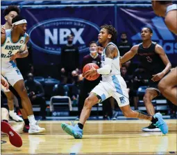  ?? Photo courtesy of URI Athletics ?? URI senior point guard Fatts Russell, right, scored 13 points in the final three minutes of regulation and overtime
to lift the Rams to an 85-77 victory over winless St. Joseph’s at the Ryan Center Sunday afternoon.