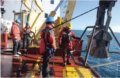  ??  ?? ARCTIC OCEAN, at sea: Members of the Canadian Coast Guard assist scientists in deploying a device to collect sediment from the Arctic ocean seabed on board the CCGS Amundsen ice-breaker September 20, 2015, to study the compositio­n of the Arctic Ocean....