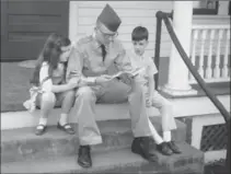  ?? CROCKER, TNS ?? Denton (Mogie) in uniform, sitting on porch steps with Candy and Randy 1965.