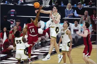  ?? PHOTOS BY ROSS D. FRANKLIN — THE ASSOCIATED PRESS ?? Purdue's Zach Edey (15) blocks the shot of NC State's Casey Morsell during Saturday's Final Four opener.