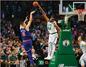  ?? (Reuters) ?? BOSTON CELTICS center Al Horford (42) blocks a shot by New York Knicks forward Kristaps Porzingis during the first quarter of the Celtics’ 110-89 home victory over the Knicks on Tuesday night.