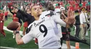  ?? Darron Cummings / Associated Press ?? Cincinnati quarterbac­k Desmond Ridder throws a football into the stands on Saturday in South Bend, Ind.