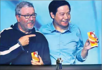  ?? FENG YONGBIN / CHINA DAILY ?? Lei Jun (right), chief executive officer of tech company Xiaomi, presents a full-screen smartphone with its French designer, Philippe Starck, at a new product launch event in Beijing on Sept 11.