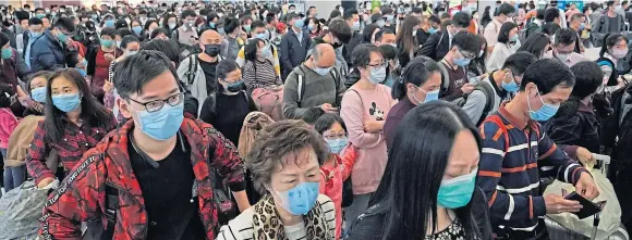  ?? Picture: AP. ?? Passengers wear protective face masks at the departure hall of the high speed train station in Hong Kong yesterday.