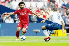  ??  ?? Liverpool’s Egyptian midfielder Mohamed Salah (left) vies with Tottenham Hotspur’s English midfielder Harry Winks during the English Premier League football match between Tottenham Hotspur and Liverpool at Wembley Stadium in London. — AFP photo