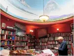  ??  ?? An array of reading matter lines the curved walls of the Slightly Foxed store. The town’s lighthouse can be spotted in the ceiling mural.