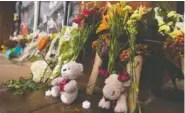  ?? AP PHOTO/STEVE HELBER ?? Memorial flowers and stuffed animals line a walkway at Scott Stadium after three football players were killed in a shooting Tuesday on the grounds of the University of Virginia in Charlottes­ville. Va.