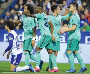  ??  ?? Vinicius Junior (centre) of Real Madrid celebrates after scoring during the Copa del Rey (Kings Cup) match against Zaragoza at La Romareda stadium in Zaragoza, on Wednesday. Real won 4-0.
— AFP