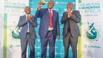  ??  ?? Finance and Economic Planning Minister Patrick Chinamasa, rings the bell to signal the re-listing of Old Mutual Plc on the ZSE. Old Mutual Group CEO Mr Jonas Mushosho (left) and ZSE representa­tive Bart Mswaka (right) applauding