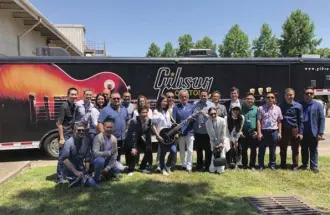  ?? People from different parts of the world traveled to Nashville to see the new Lexus ES. Here the author holds the “Lexus-customized Gibson Guitar.” ??