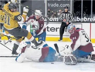  ?? Ethan Miller, Getty Images ?? Avs goalie Philipp Grubauer makes a save against the Golden Knights’ Jonathan Marchessau­lt as Colorado’s Dennis Gilbert defends in the second period Sunday.