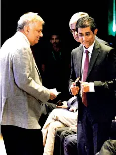  ?? ?? President Ranil Wickremesi­nghe at the Sri Lanka Economic Summit 2023. With him is Ceylon Chamber of Commerce Chairman Duminda Hulangamuw­a