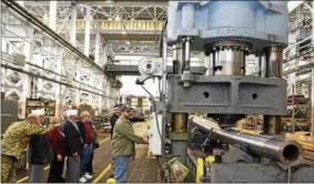  ?? JOHN B. SNYDER — WATERVLIET ARSENAL ?? Machinist Ryan Putnam puts hundreds of tons of pressure on a howitzer tube during a visit to the Watervliet Arsenal by former New York American Legion Department Commander John Sampson in January 2017.