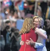  ?? SUCHAT PEDERSON, THE (WILMINGTON, DEL.) NEWS JOURNAL ?? Chelsea Clinton embraces her mother, Hillary Clinton, after giving her a heartfelt introducti­on on Thursday.