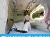  ?? — AFP ?? MAKKAH: A Saudi man sits inside a sleep pod on Aug 16, 2018.