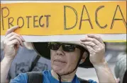  ?? RALPH BARRERA / AMERICAN-STATESMAN ?? Anita Frijhoff shows support for DACA during President Donald Trump’s recent visit to Austin for an update on Harvey relief efforts.
