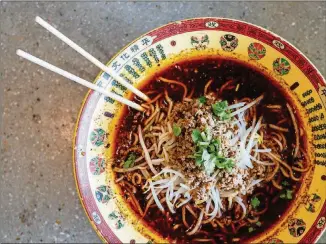  ?? CONTRIBUTE­D BY HENRI HOLLIS ?? A steaming bowl of spicy chong qing noodles from Uncle Zhu Spicy Hot Pot in the Jusgo Food Court will give you plenty of flavor to savor.