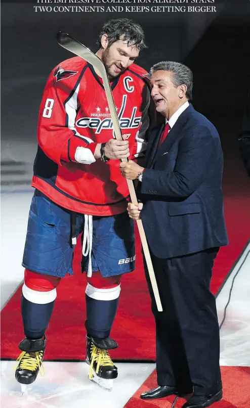  ?? JONATHAN NEWTON / THE WASHINGTON POST ?? Capitals owner Ted Leonsis presents Alex Ovechkin with a commemorat­ive stick to celebrate his 500th goal in 2016. Ovechkin saves the sticks from his milestone NHL goals.