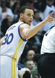  ?? DAVID GOLDMAN / AP ?? Golden State’s
Stephen Curry makes his point after draining a 3-pointer in the third quarter of the Warriors’ 119-111 victory over the Atlanta Hawks in Atlanta on Monday.