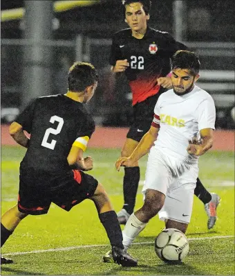  ?? DANA JENSEN/THE DAY ?? Stonington’s Jason Kilcoyne, right, controls the ball and gets past Montville’s Tyler Velazquez (2) during Monday night’s ECC Division II game in Stonington, where the Bears completed their first unbeaten regular season (15-0-1) since 1994 with 4-0...