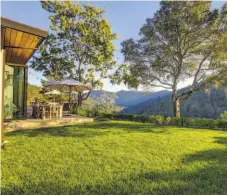  ??  ?? The Kentfield four-bedroom home enjoys a level lawn and views of Mount Tamalpais.