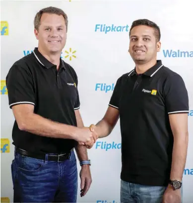  ??  ?? A DONE DEAL: Walmart CEO Doug McMillon ( L) with Flipkart Group CEO Binny Bansal
