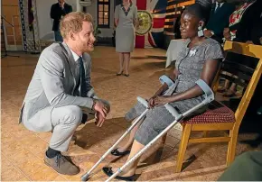  ?? GETTY IMAGES ?? Prince Harry meets landmine victim Sandra Tigica, who met Princess Diana during her visit to Angola in 1997.