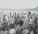  ?? AP ?? Inmates at Attica State Prison in Attica, New York, raise their fists in a show of unity after prisoners seized control of the prison on Sept. 9, 1971.