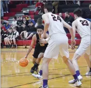  ?? ANNETTE BEARD/ PEA RIDGE TIMES ?? Tiger Carl Von Bergen (No 15) drives down the court as Pea Ridge Blackhawk seniors Brandon Whatley (No. 24) and Wes Wales (No. 23) guard him Friday, Feb. 7, in Pea Ridge High School Blackhawk gym during the Colors Day game.