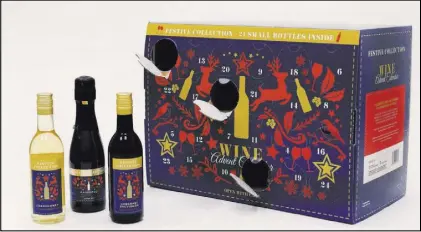  ?? Mark Lennihan The Associated Press ?? Aldi’s wine advent calendar is displayed in New York. The cardboard calendars, usually filled with chocolates, are now being stuffed with cans of beer or bottles of wine or chunks of cheese.