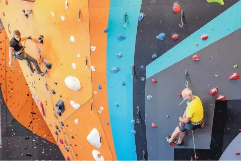  ?? ANTHONY JACKSON/ JOURNAL ?? Clark Frauenglas­s, left, and Bryan Pletta, right, make their way up the main rock climbing wall at Stone Age North, which opened Aug. 8.