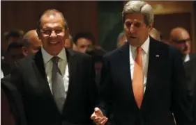  ?? PHOTOS VIA AP ?? U.S. Secretary of State John Kerry (left), and Russian Foreign Minister Sergey Lavrov, walk in to their meeting room Friday in Geneva, Switzerlan­d, to discuss the crisis in Syria. KEVIN LAMARQUE/POOL