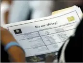  ?? LYNNE SLADKY — THE ASSOCIATED PRESS FILE ?? A job applicant looks at job listings for the Riverside Hotel at a job fair hosted by Job News South Florida in Sunrise, Fla.