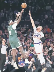  ?? ?? Bobby Porti of the Milwaukee Bucks shoots against Taj Gibson of the New York Knicks during their game at Madison Square Garden in New York City.