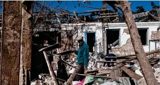  ?? LYNSEY ADDARIO/THE NEW YORK TIMES ?? Residents on Saturday sift through the debris of their homes following a Russian strike on the small village of Malotarani­vka, near Kramatorsk, Ukraine. Fighting has intensifie­d in the Donbas region in the run-up to Monday, an annual holiday marking the Soviet defeat of Nazi Germany.