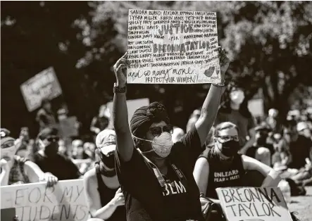  ?? Marie D. De Jesús / Staff photograph­er ?? A woman at a Houston rally Friday holds a sign with the names of black women who have died when shot by or in custody of the police. Friday’s rally seeks justice for Breonna Taylor, who was fatally shot by police on March 13 in her Louisville, Ky., home.