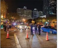  ?? (TNS/Sun Sentinel/Michael Laughlin) ?? Police officers keep watch as a crowd starts to gather recently on Himmarshee Street in Fort Lauderdale, Fla. Under a new state law, excessivel­y loud noises coming from vehicles on Florida’s streets can result in a citation costing as much as $115.