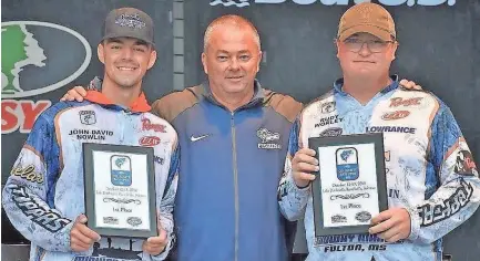 ?? SUBMITTED ?? John David Nowlin (left) and Rudy Worley celebrate with their coach Shane Cox, Blue Mountain College’s victory at the American Fishing Tackle Company Collegiate Bass Tournament on Lake Dardanelle near Russellvil­le, Ark.