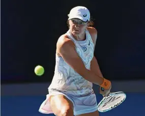  ?? Mackenzie Sweetnam / Getty Images ?? Iga Swiatek of Poland plays a backhand during the third round of the Australian Open on Friday.
