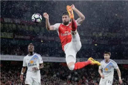  ??  ?? LONDON: Arsenal’s Olivier Giroud kicks the ball across goal, from which teammate Alexis Sanchez scored their side’s second goal during the English Premier League soccer match between Arsenal and Sunderland at the Emirates Stadium. —AP