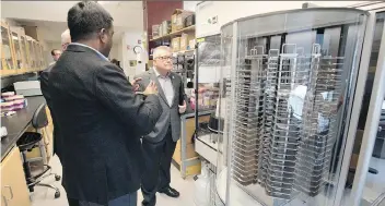  ?? TROY FLEECE ?? University of Regina associate professor Mohan Babu takes Public Safety Minister Ralph Goodale on a tour through a lab at the university on Wednesday. Goodale was at the university to announce federal funding for three research projects, including...