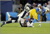  ?? MARK J. TERRILL — THE ASSOCIATED PRESS ?? Los Angeles Chargers running back Austin Ekeler, right, is hit by Denver Broncos cornerback Damarri Mathis, center, during the first half Monday in Inglewood.