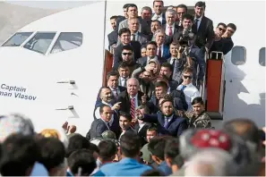  ??  ?? Centre of attraction: Dostum arriving at the Hamid Karzai Internatio­nal Airport in Kabul. — Reuters