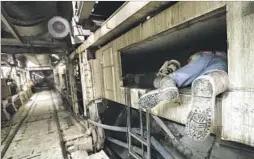  ??  ?? MINER Moises Aguayo squeezes into a tight space while working inside the 400-foot-long, 1,000-ton beast known as the tunnel boring machine.