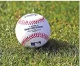  ?? Associated Press file photo ?? ■ A baseball is shown on the grass at the Cincinnati Reds baseball spring training facility on Feb 17, 2017, in Goodyear, Ariz.