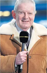  ??  ?? John Motson wearing his trademark sheepskin coat