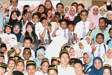  ??  ?? Voices of the future: Rohani and Khairy posing with the children at the TN50 dialogue session.