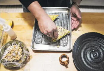  ??  ?? Owner and James Beard Award-nominated chef Victor Parra Gonzalez prepares camote tetelas at Las Puertas in Buffalo.