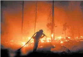  ?? NOAH BERGER/AP ?? Fires such as the Creek Fire, above, have taxed the human, mechanical and financial resources of the nation’s wildfire-fighting forces to a degree that few past blazes did.